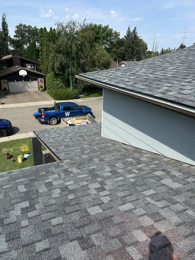 The W Contracting truck on site while the house and garage roofs go on, Saskatoon, SK, on the Home page